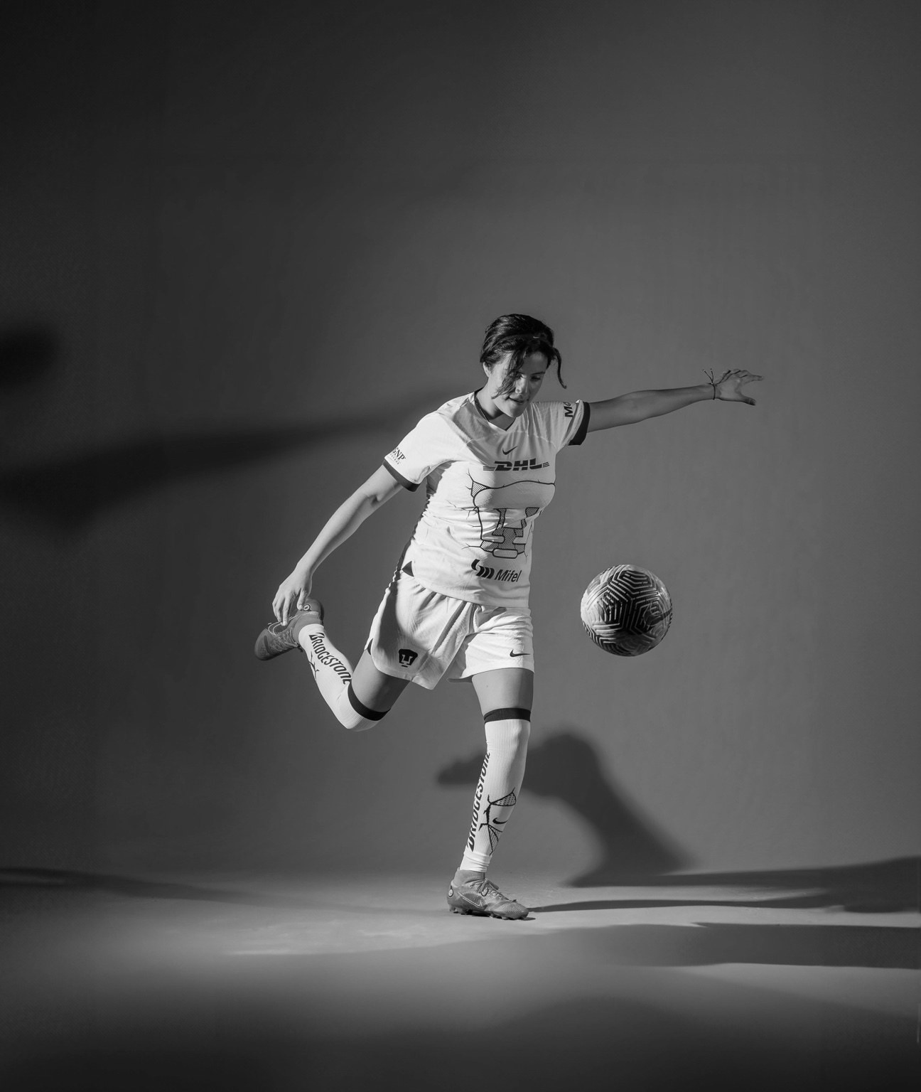 Female football player kicking the ball